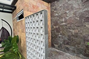 A stone wall with a white lattice fence. - Medea Villa Banyuwangi (Banyuwangi Sub-District)