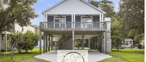 A two-story building with a balcony, a covered walkway, and a sign reading "The Golden Oak Island".