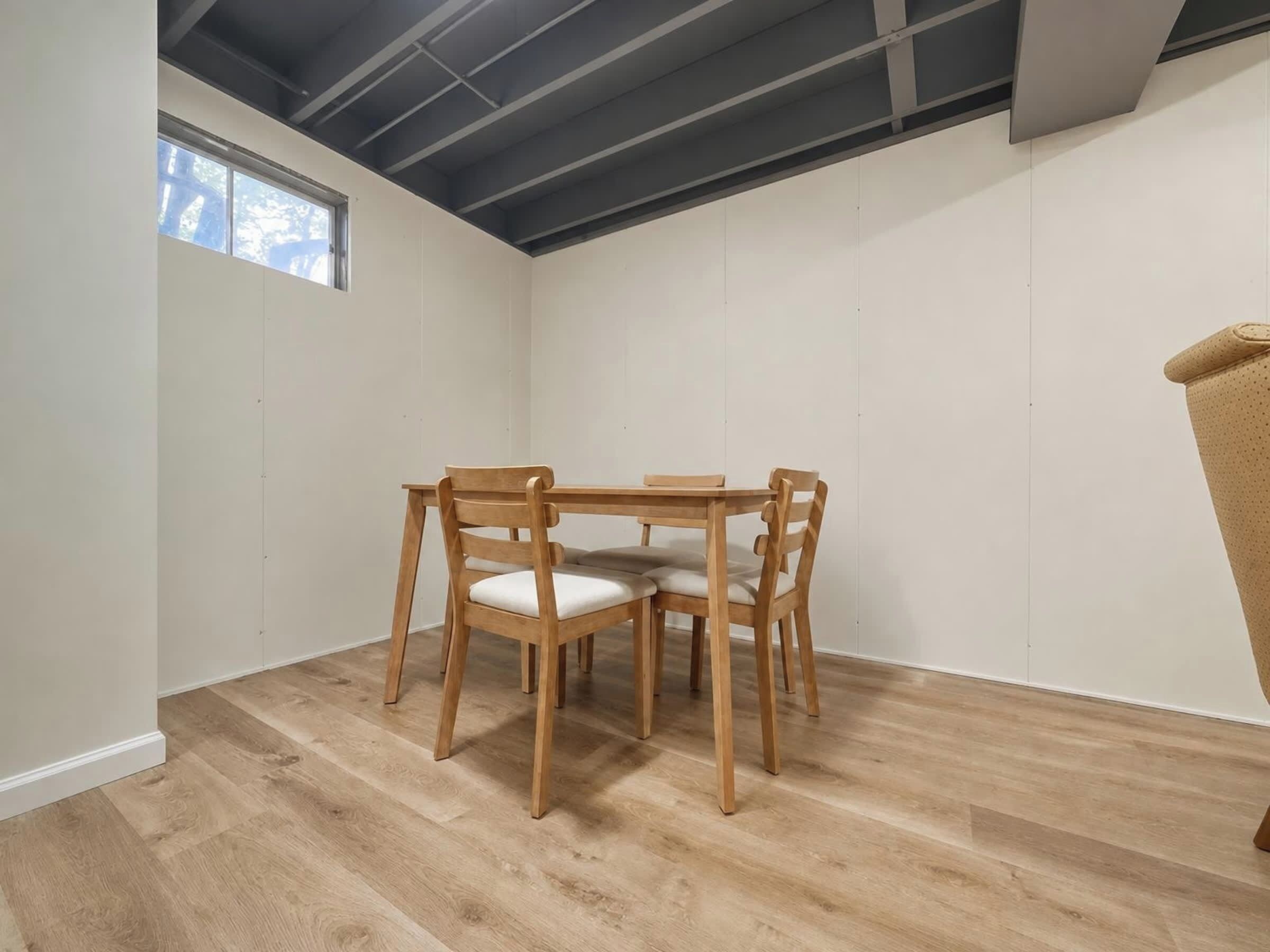 Una habitación con una mesa de comedor de madera y sillas, un ventanal y un techo con vigas a la vista.