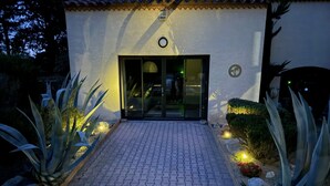 A building with a tiled roof, a glass door entrance, and a paved pathway leading to it. - CASITA LATINA - Adults Only (Saint Genis des Fontaines)