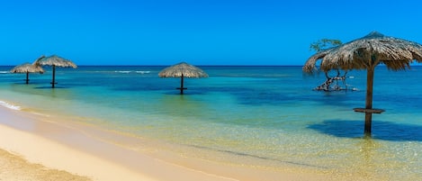 Private beach, white sand, sun loungers, beach umbrellas