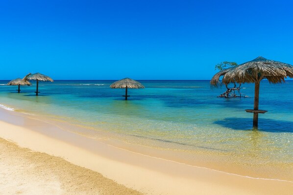 Private beach, white sand, sun loungers, beach umbrellas