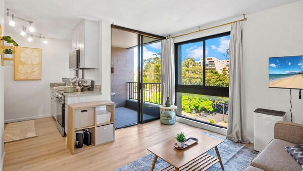 A modern apartment with a kitchen, dining area, and a balcony with a city view.