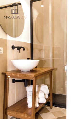 A bathroom with a white vessel sink, a wooden vanity, and a glass shower enclosure. - Maqueda 259 - In Palermo's Lively Heart (Palermo)