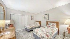 A bedroom with two beds, a large mirror, and a window with blinds. - Huge Heated Pool ❤ Short Walk to the Beach, ride FREE Trolley around the Key! (Siesta Key)