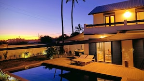 A modern house with a swimming pool, a patio with lounge chairs, and a view of palm trees. - 🌴 Villa Capeline Sea View Haven - Pool & tropical garden 2 min. from the lagoon (Saint-Paul)