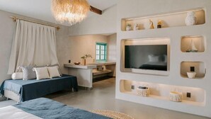 A modern bedroom with a bed, a TV mounted on the wall, and a small desk area. - Pousada Boutique Preá Beira Mar - Raro Life (Cruz)