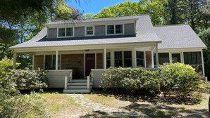A two-story house with a covered porch and a stone pathway leading to the entrance. - 3 Bedroom house in Cotuit with screened porch and bay view (Barnstable)