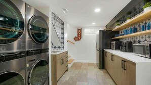 A compact kitchen with built-in appliances, wooden cabinets, and a tiled backsplash. - Sleeps 16 - 15 min/Downtown, 10 min/Medical Center (Aurora)