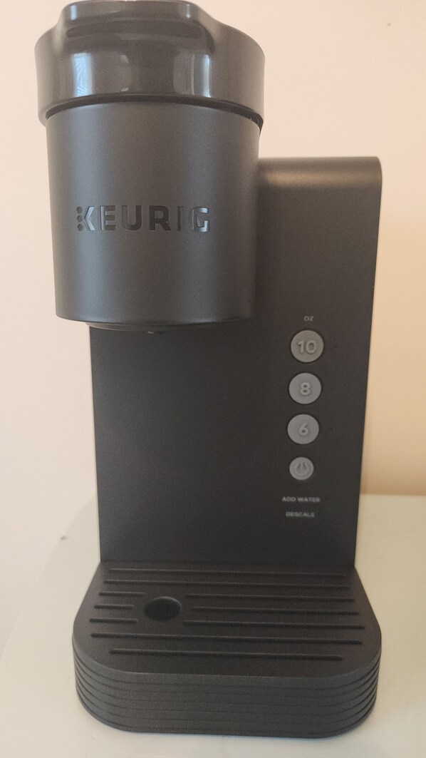 A black Keurig coffee maker with a water reservoir, a power button, and a 10-cup capacity indicator. - Magnolia Hideaway 2-BR Apt in center of Town of Colonial Beach (Colonial Beach)