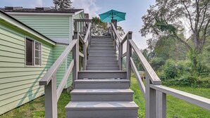A wooden staircase with a handrail leading to a house with a green exterior. - Quaint & Charming Cherry Valley Escape! (Cherry Valley)