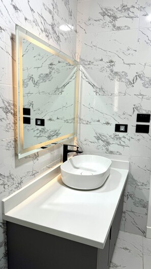 Shower, hair dryer, towels, toilet paper