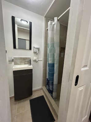 Shower, hair dryer, towels, soap