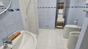 A bathroom with a white sink, a toilet, and a shower area. - Double or Twin - Private Outdoor Bathroom and Private Parking in Loco (Potenza)