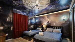 A bedroom with two beds, a night sky mural, and a fireplace. - Windsor Island 10br Waterpark Free (Davenport)