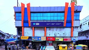 A multi-story building with a prominent SBI bank sign, indicating a bank branch. - HOTEL SAROVAR GRAND  (Ahmedabad)