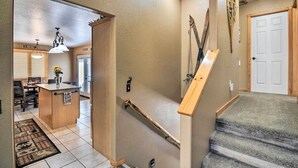 A home interior with a staircase, a kitchen area, and a dining space. - Family-Friendly Home w/ Hot Tub: 1 Mile to Downtown (Estes Park)
