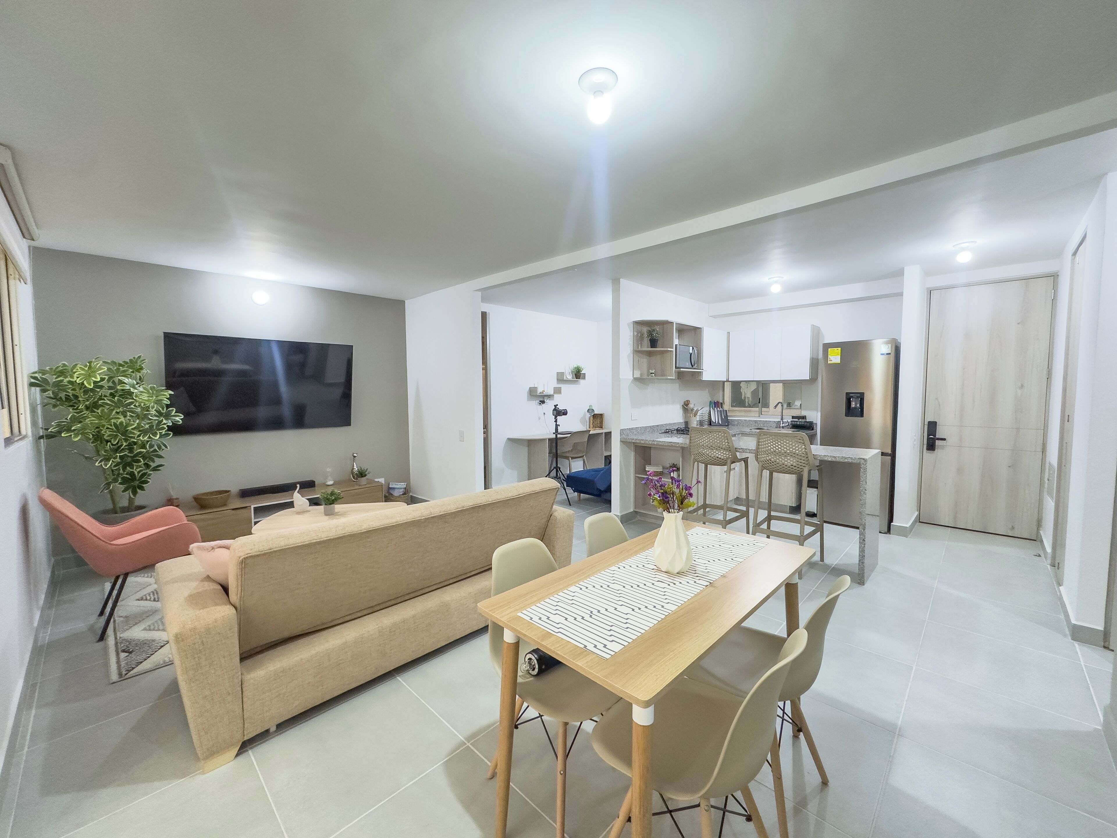 A modern apartment with a living area, dining space, and kitchen.