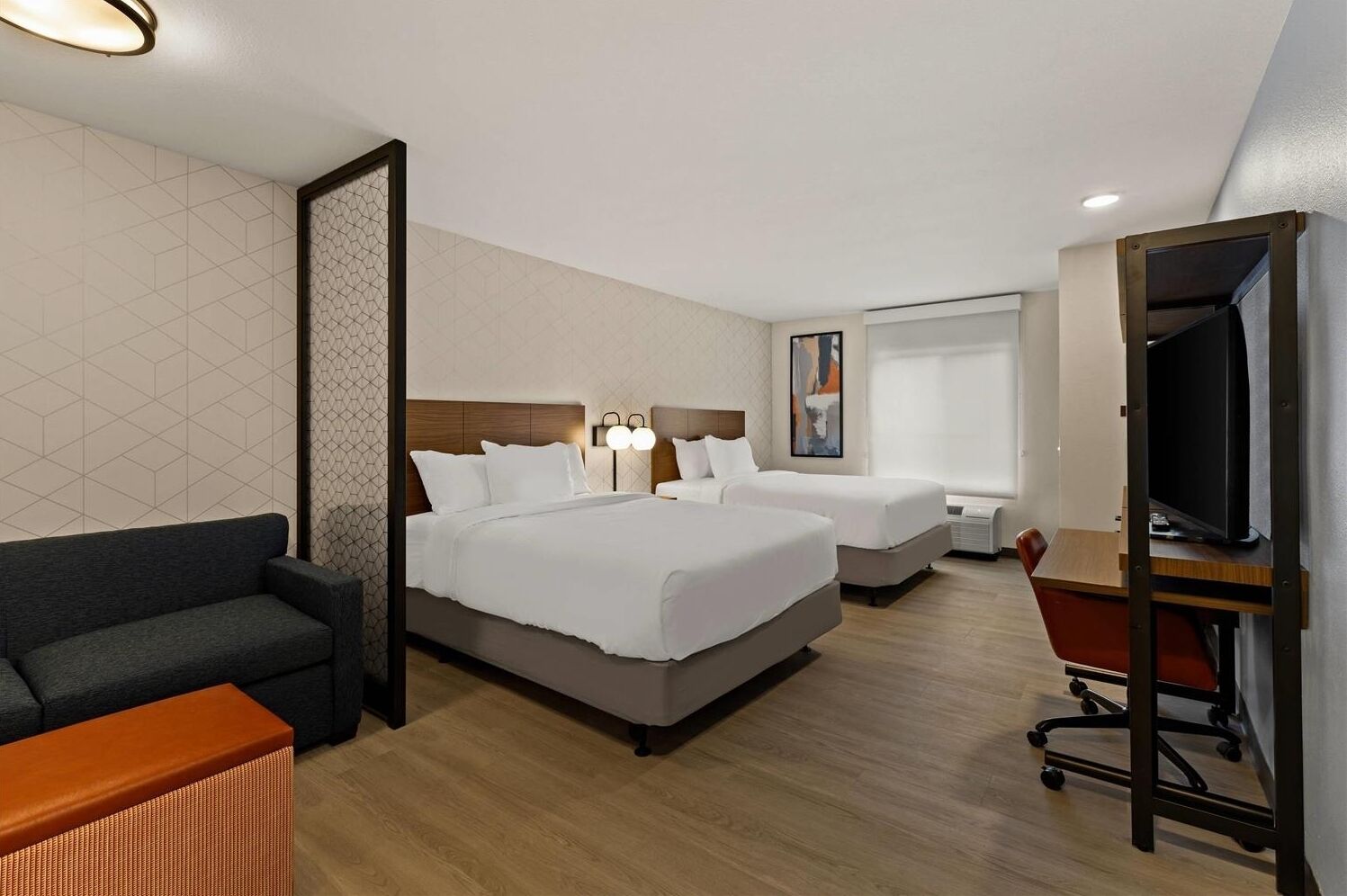 Unwind in a spacious double-queen room with modern comfort.