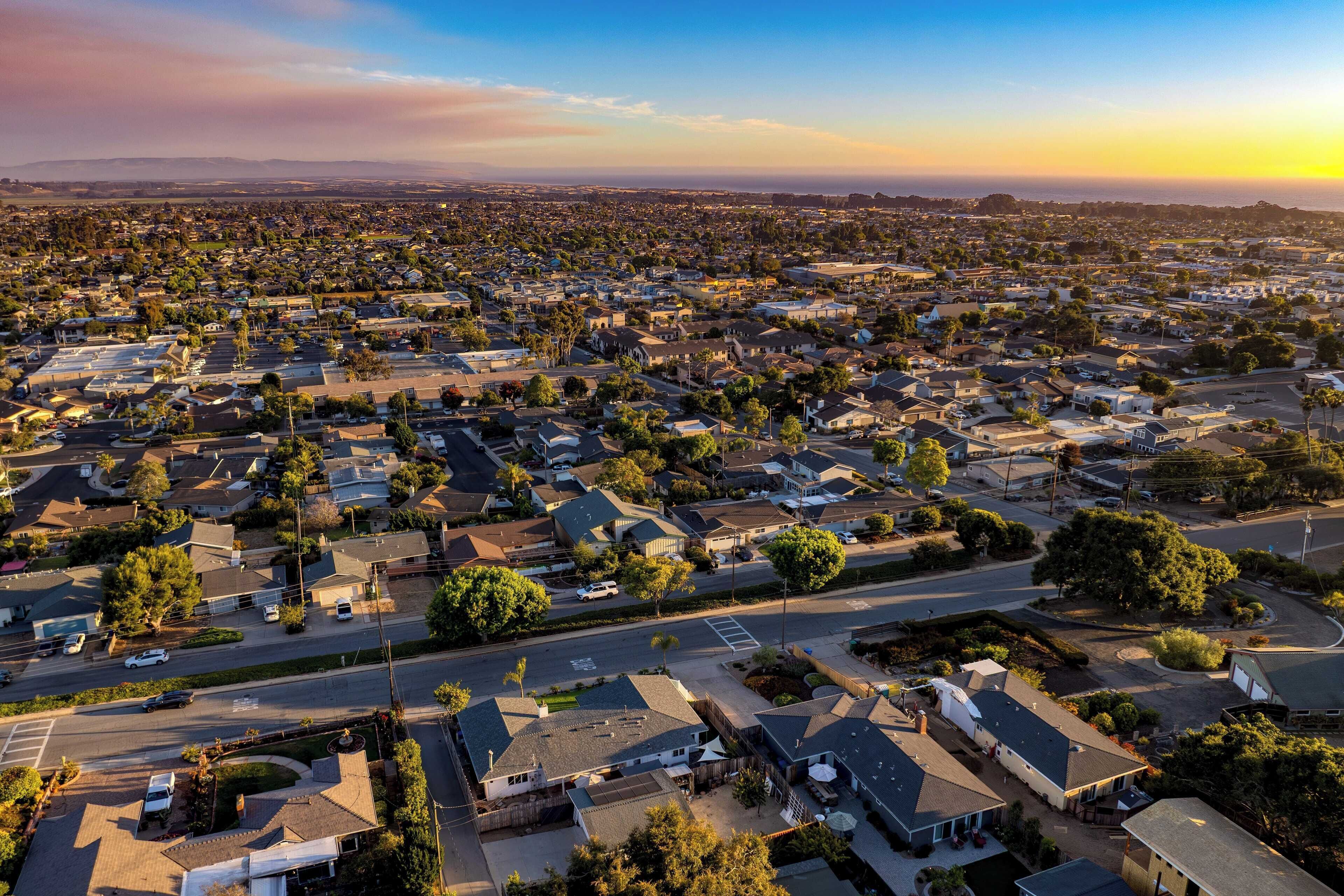 An aerial view of a residential neighborhood with houses, streets, and trees.