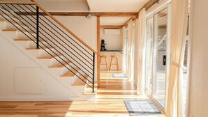 A staircase with wooden steps and black railings leading to a landing.