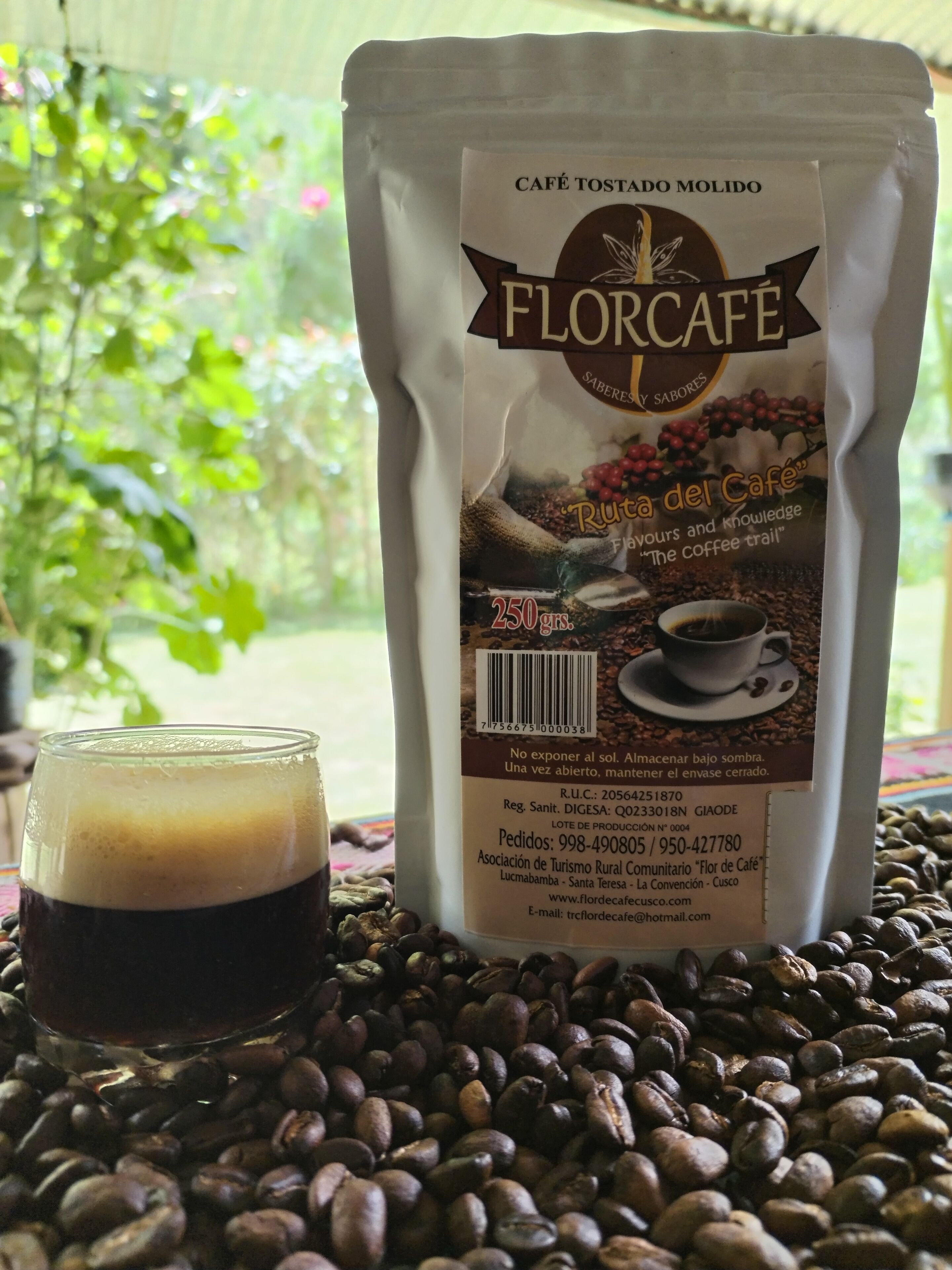 A coffee bag labeled 'Florcafe' with a glass of coffee and coffee beans in the foreground.