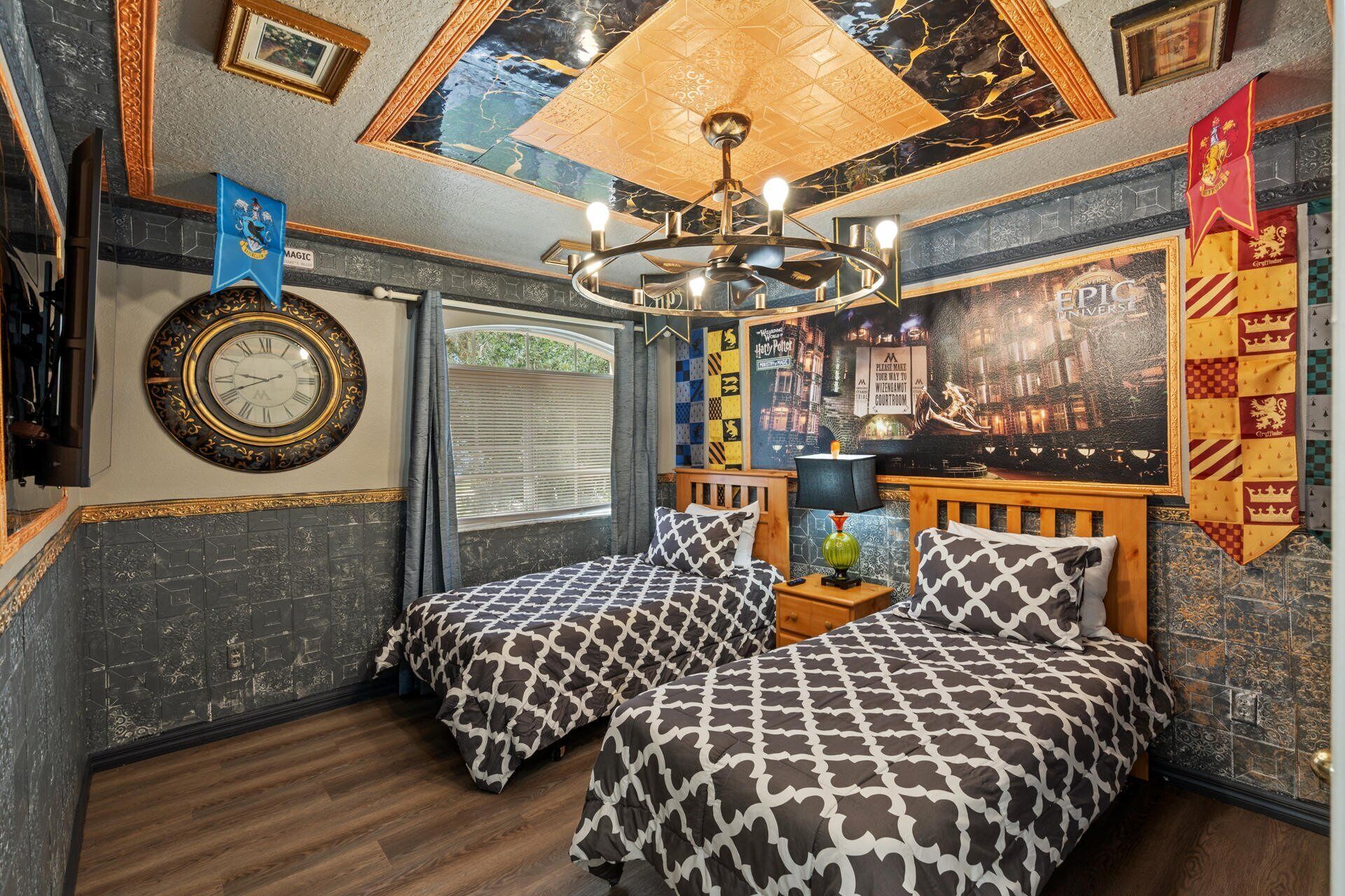 A room with two beds, a large wall clock, and a ceiling mural.