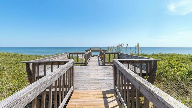A wooden boardwalk leading to a beach with a clear view of the ocean. - Gone Coastal | Oceanfront | Community Pool (Kill Devil Hills)