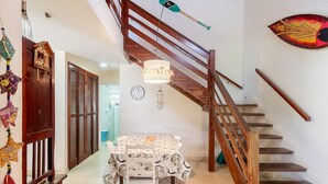 A staircase with wooden railings, a dining table with a patterned tablecloth, and a wall clock. - House With Barbecue 350m From the Beach Rul0035 (Ubatuba)