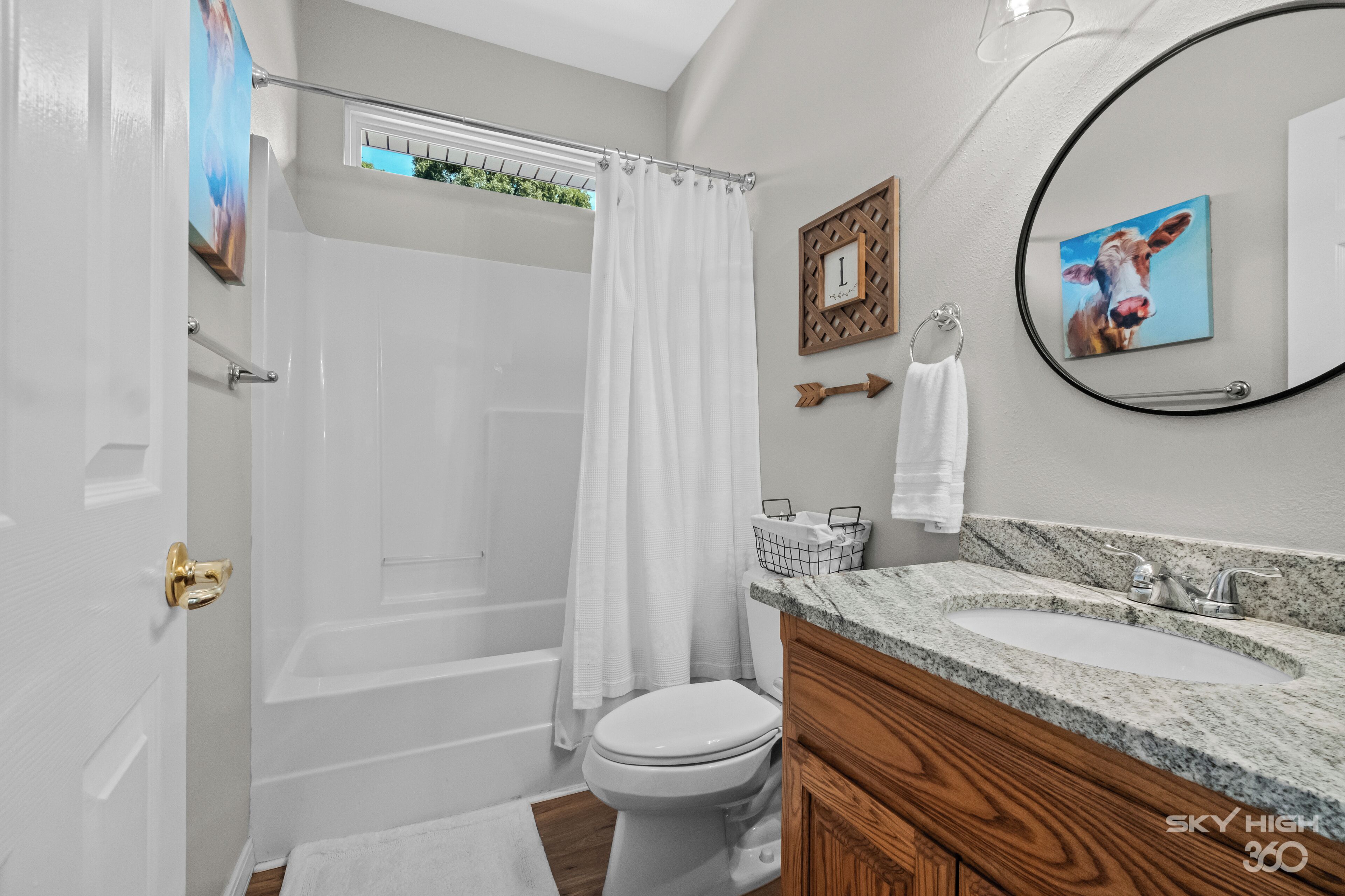 A modern bathroom with a bathtub, toilet, and sink.