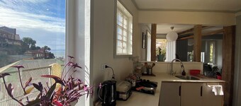 House with large terrace, patio and excellent ocean view, steps from downtown.