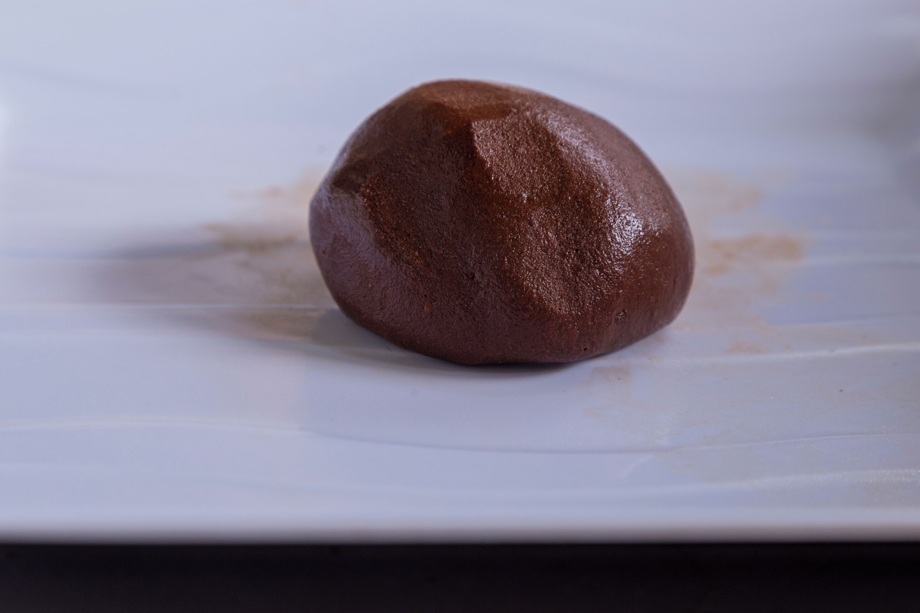 A single chocolate dessert on a white plate.