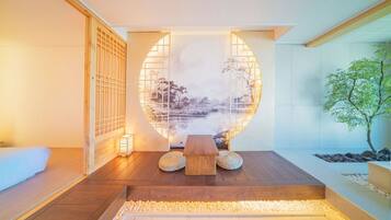 A traditional Japanese room with tatami flooring, a low wooden table, and a shoji screen.