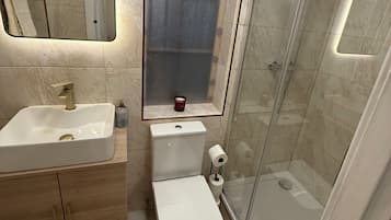 Shower, towels, soap, toilet paper