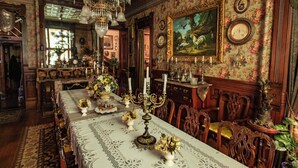 A formal dining room with a long table, ornate candelabras, and classic wooden furniture. - The Stegmaier Guest House (Wilkes-Barre)