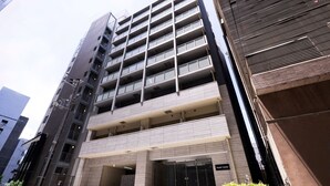 A multi-story building with a modern architectural design, featuring a prominent entrance with glass doors and a sign that reads "Regale Namha." - Regale Namba (Osaka)
