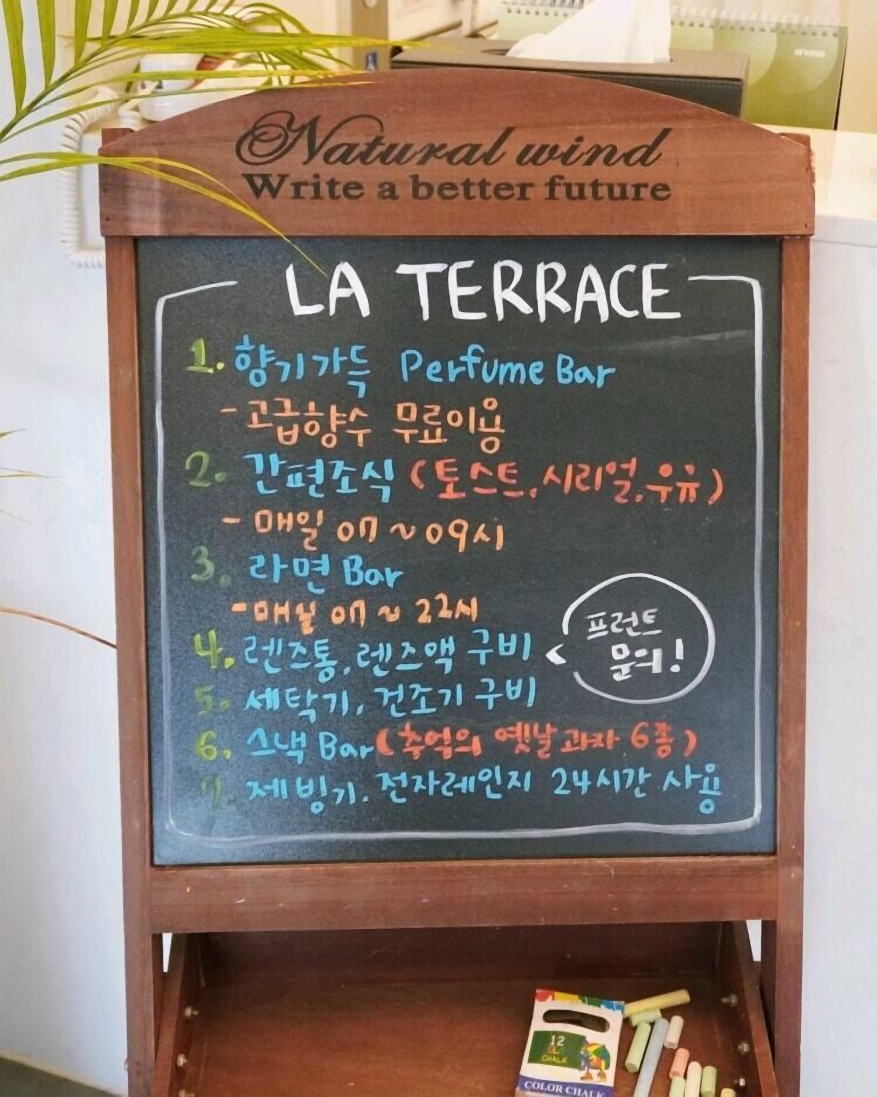 A chalkboard menu at La Terrace, listing various bars and their hours.
