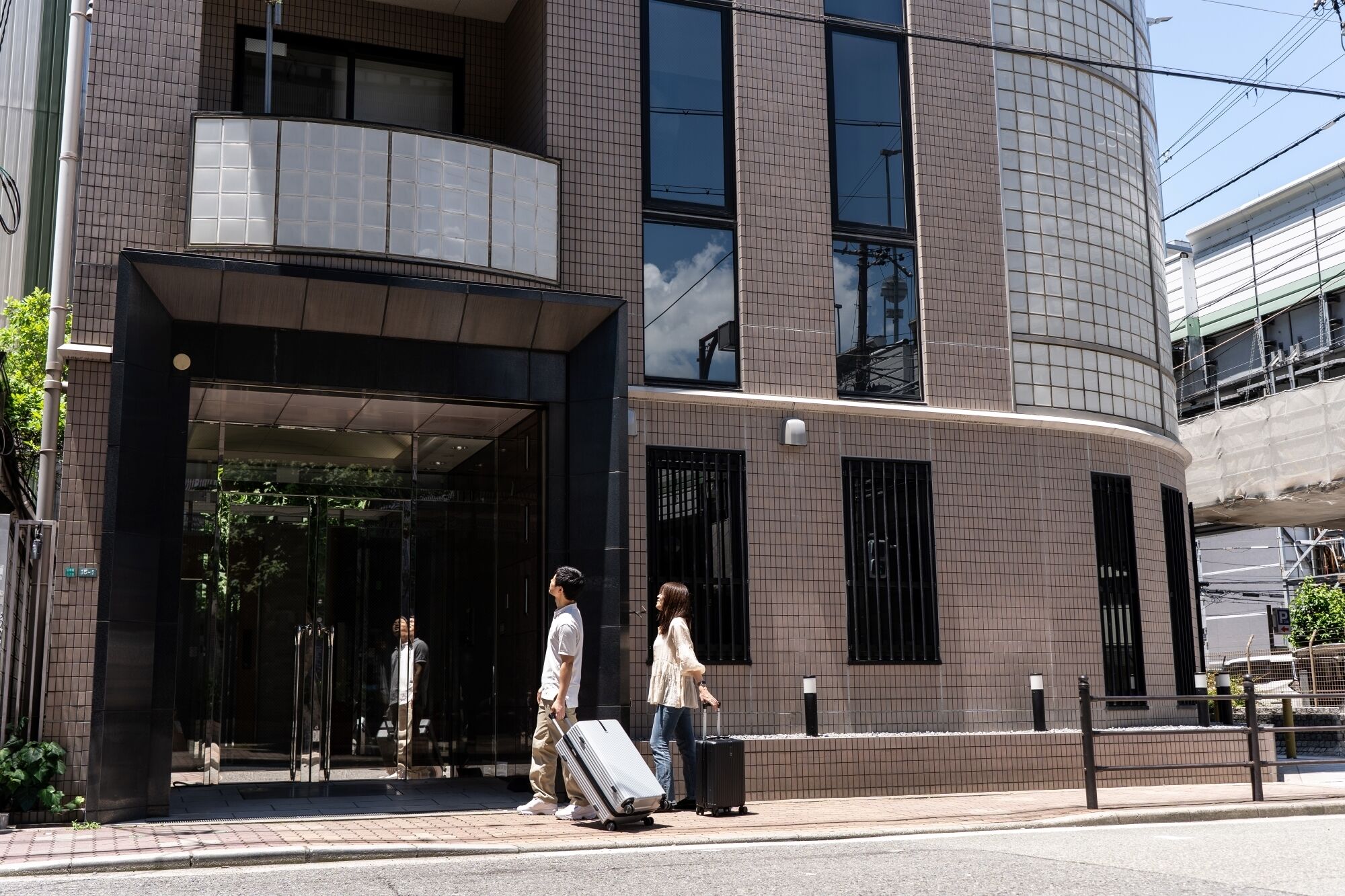 A modern building with a curved facade, large windows, and a glass entrance.