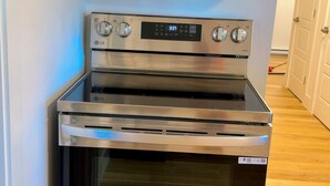 A modern kitchen with a built-in microwave above a stainless steel oven. - Home away from home. Perfect place to relax (Riverview)