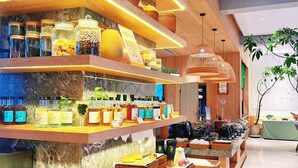 A buffet area with various food items and condiments. - YangShuo Percent Hotel (Guilin)