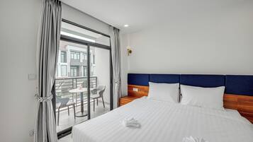 Deluxe Double Room, Balcony, Pool View | Minibar, in-room safe, blackout curtains, iron/ironing board