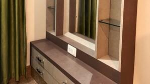 A bathroom vanity with a mirror, a shelf, and a drawer.