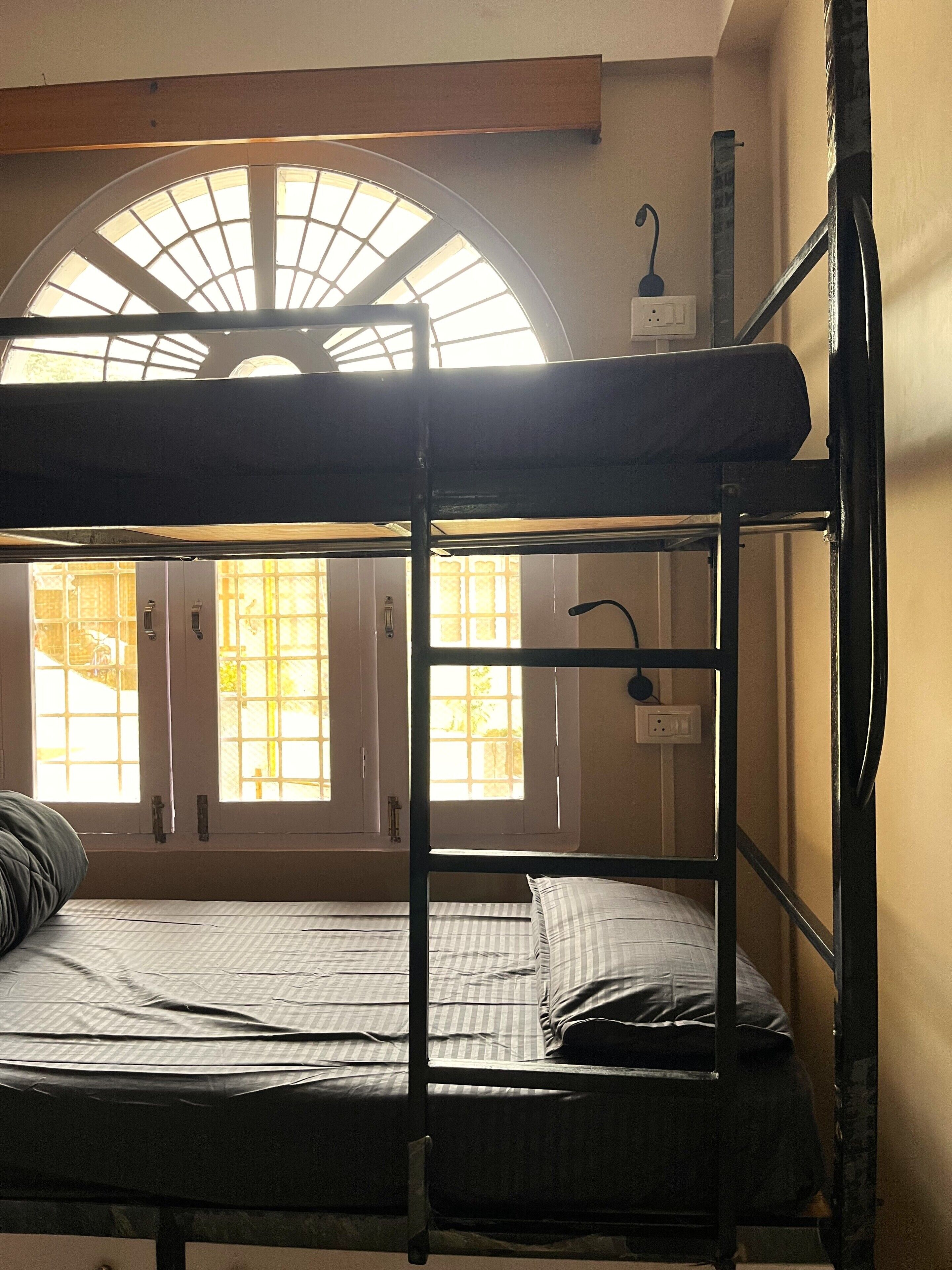 A bunk bed room with a skylight, a window, and a door.