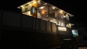 A two-story building with a sign reading "YOGSTEL" at the ground level.