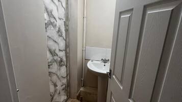 Shower, hair dryer, towels, toilet paper