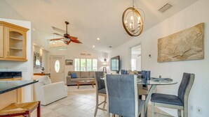 A spacious living area with a dining table, chairs, a sofa, and a ceiling fan. - Canal-Front Relaxation: Crystal River Home w/ Dock (Crystal River)