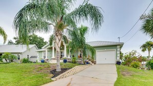 A residential area with houses, a driveway, and palm trees. - Canal-Front Relaxation: Crystal River Home w/ Dock (Crystal River)