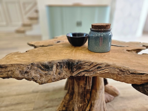 A rustic wooden table with a jar and a bowl on top.