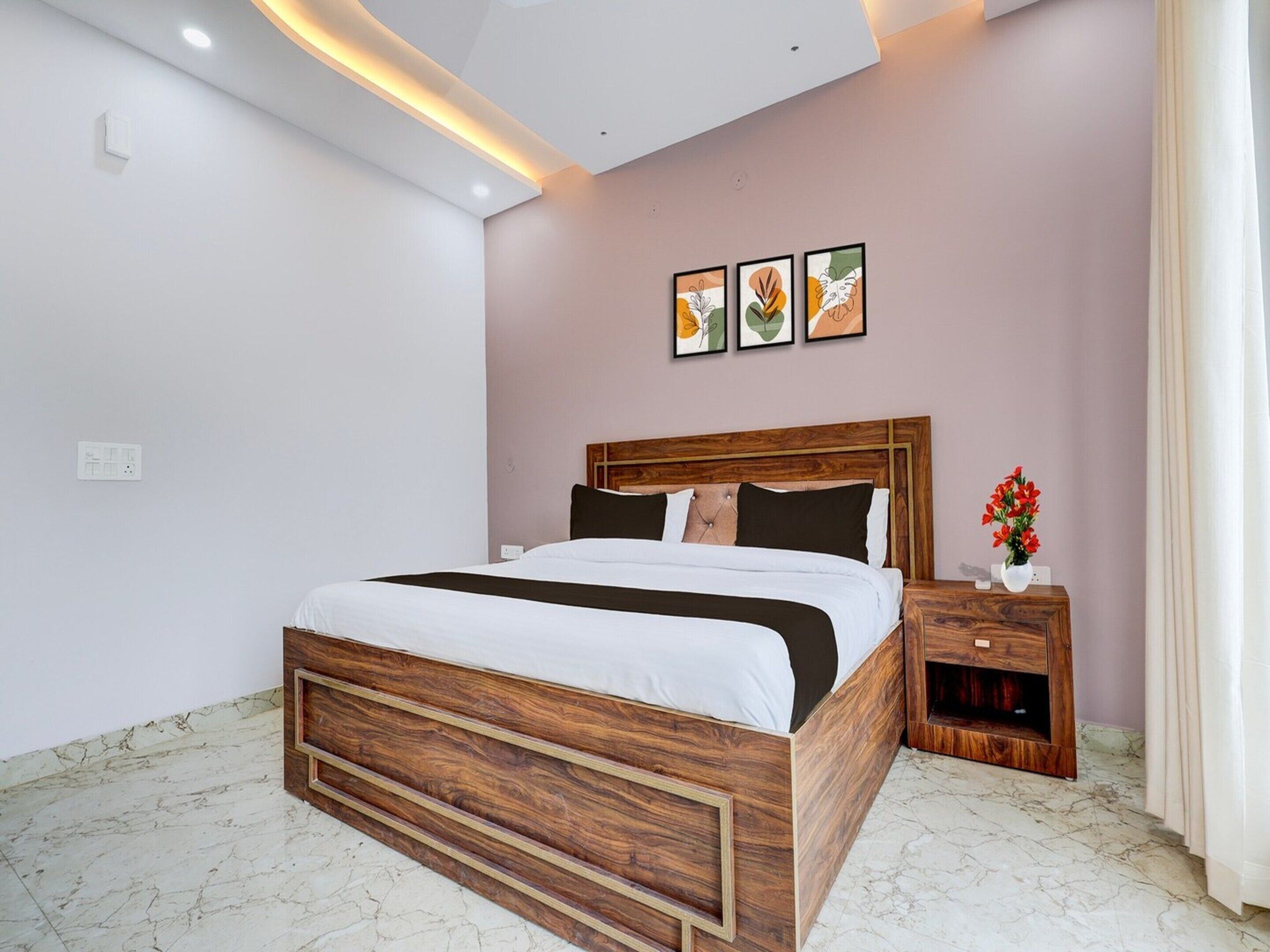 A modern bedroom with a wooden bed, a nightstand, and a wall-mounted artwork.