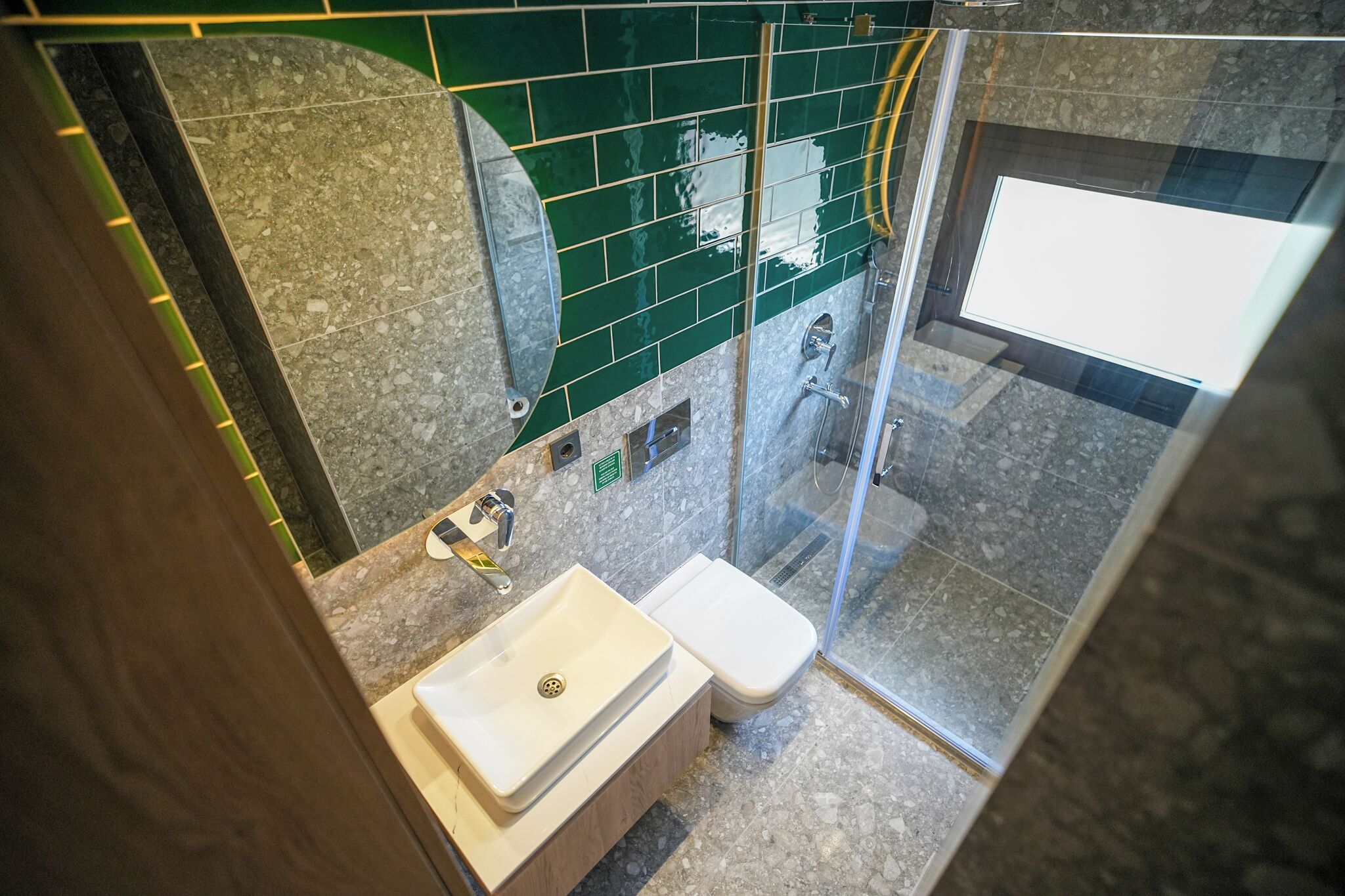 A bathroom with a shower, toilet, and sink.
